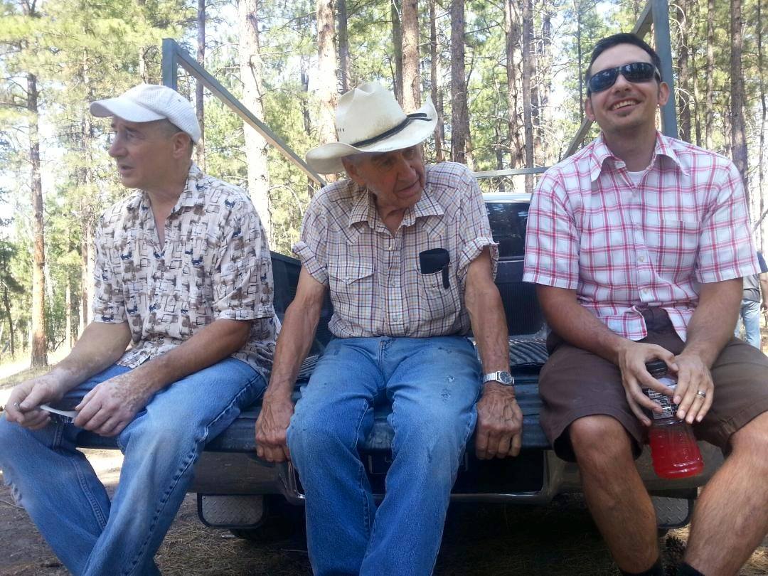 Jay, Grandpa, and Beau sitting on the tailgate
