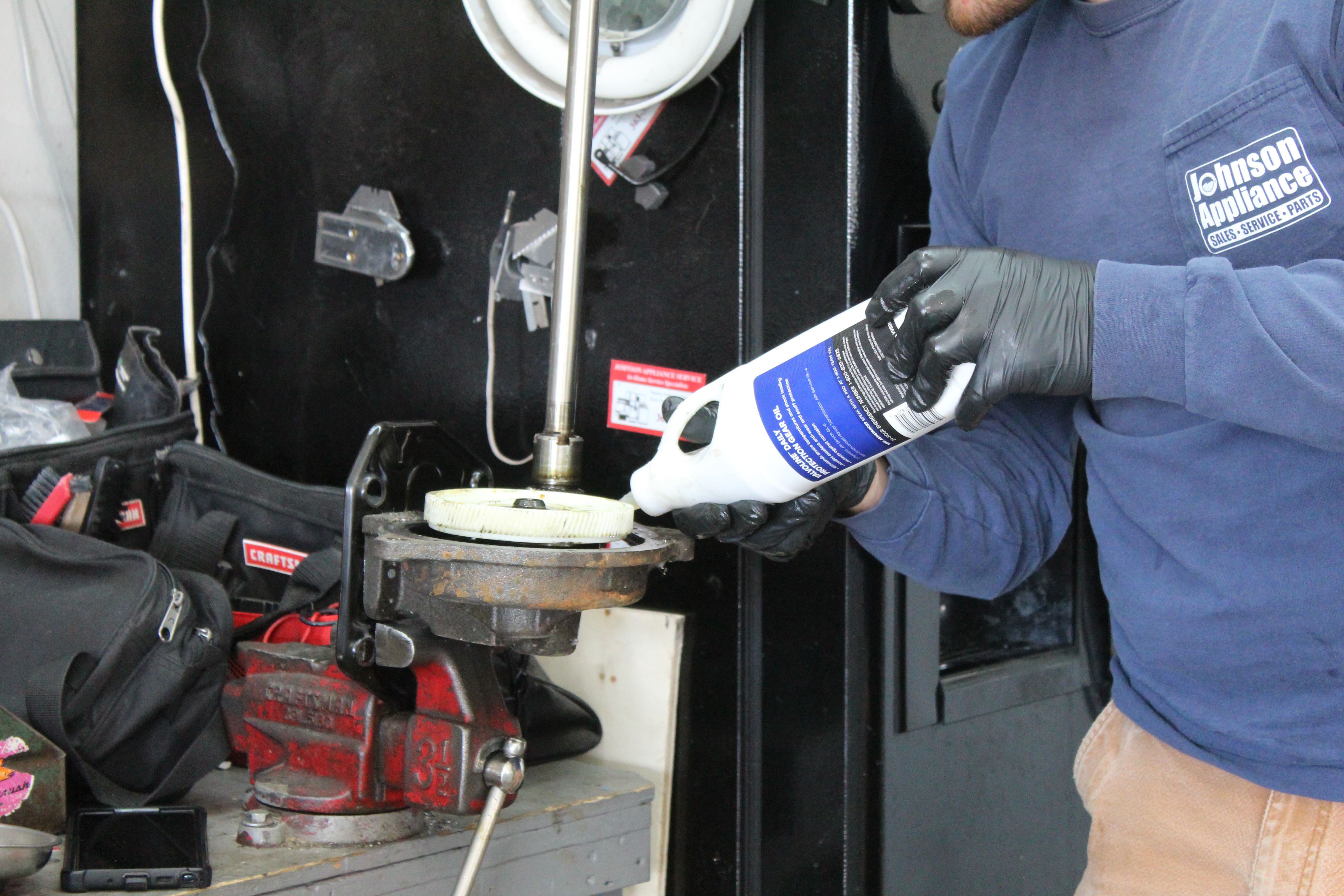 Zachary working on a washer transmission